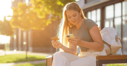 Woman using credit card on her phone