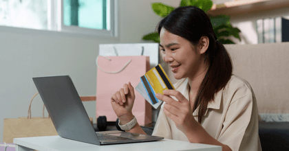 Woman with multiple credit cards and computer