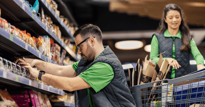 Grocery store workers stocking shelves