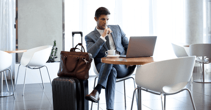 Man sitting at airport lounge with luggage