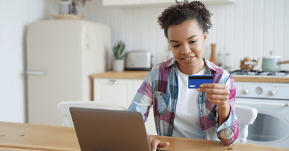Woman on laptop with credit card