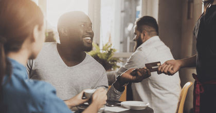 Man using credit card at restaurant
