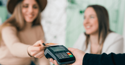 Woman using credit card to pay