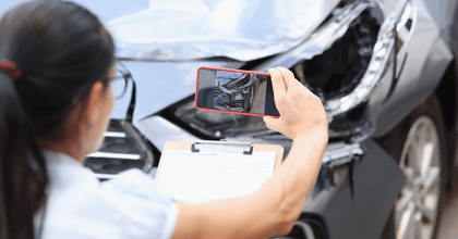 Car insurance adjuster taking photo of accident
