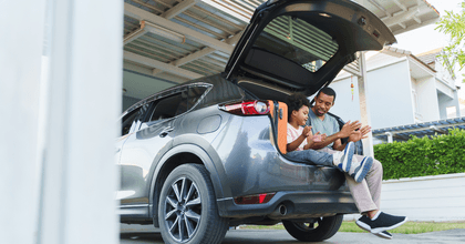 Father and son sitting in car on vacation
