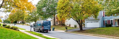 Amazon delivery van drives down streets of residential neighborhood