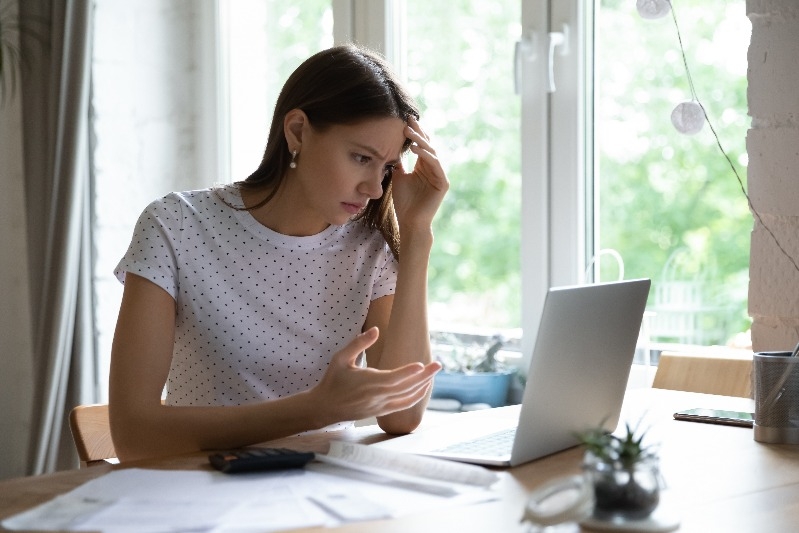 Annoyed woman looks at computer
