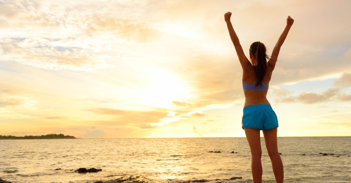 woman stretching on beach