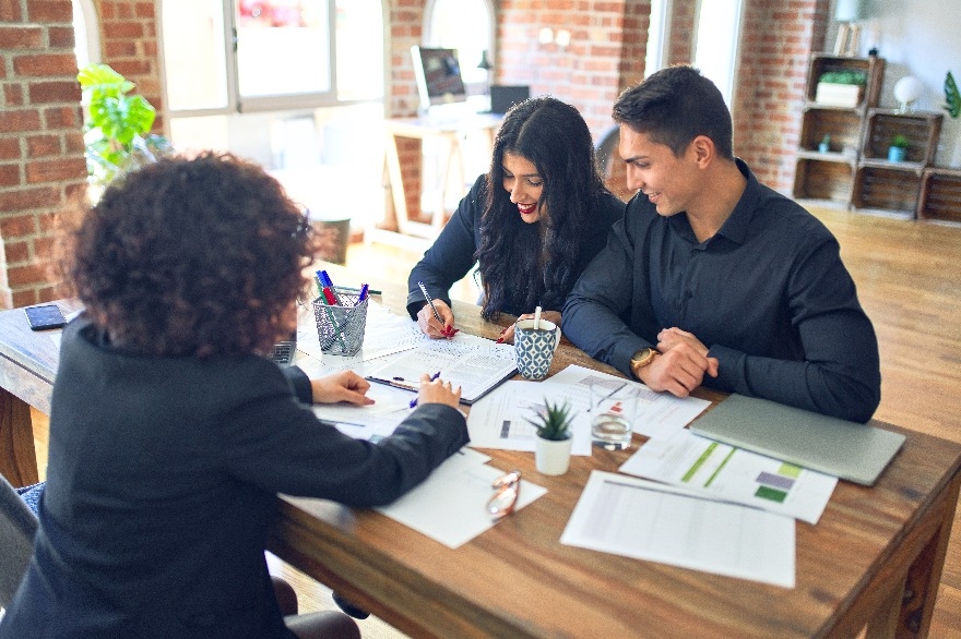 Couple sign mortgage loan contract