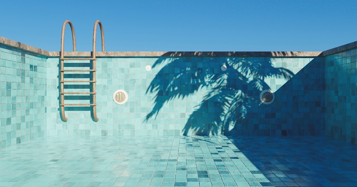 empty swimming pool with rusty stairs and tile floor 