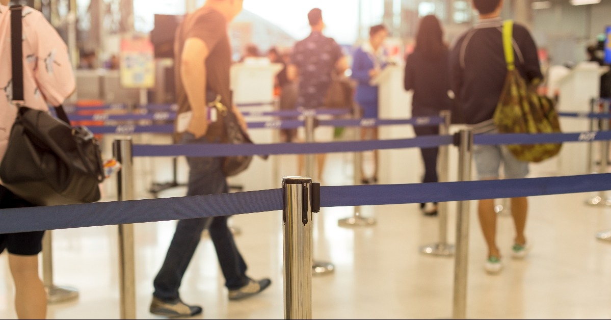 Passengers walking through check-in line at the airport
