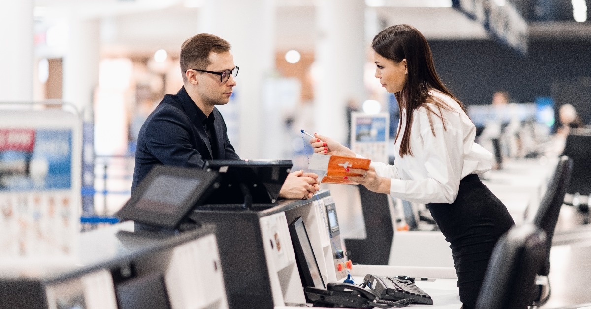 businessman handing over air ticket at airline check in counter