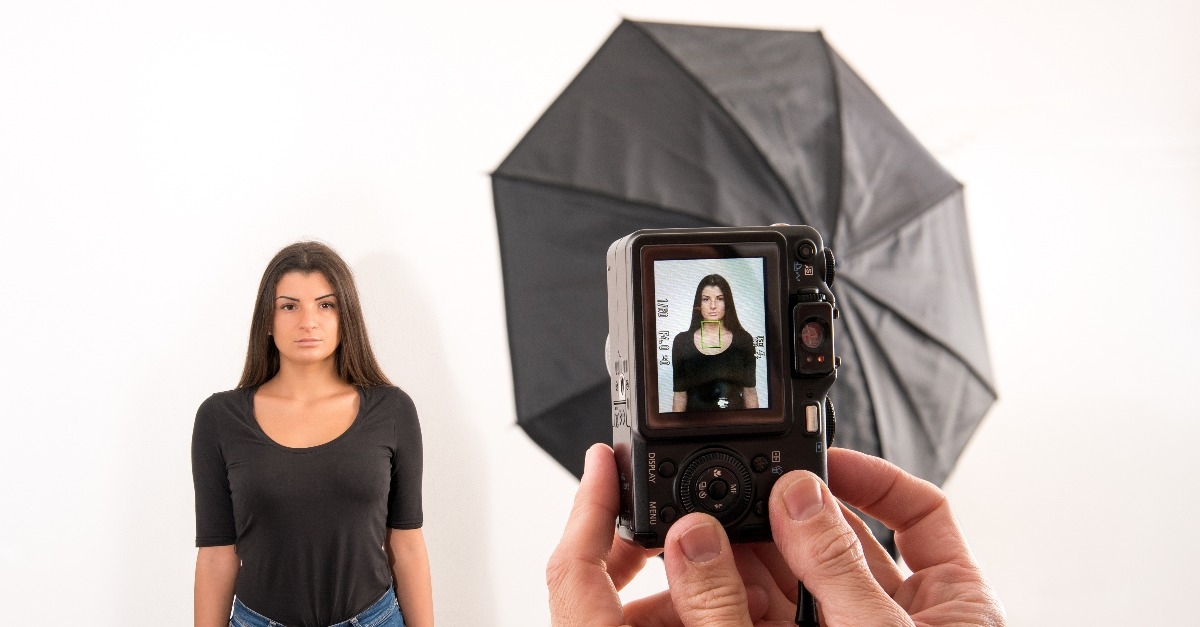 woman posing for her license photo