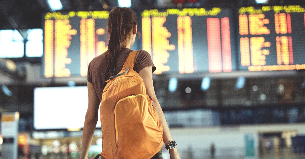woman looking at the flight information board