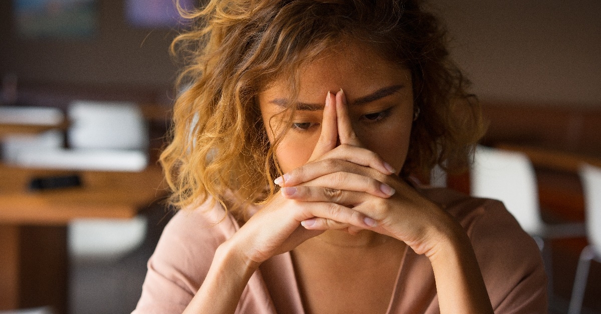 Tired Young Woman Leaning Head on Hands