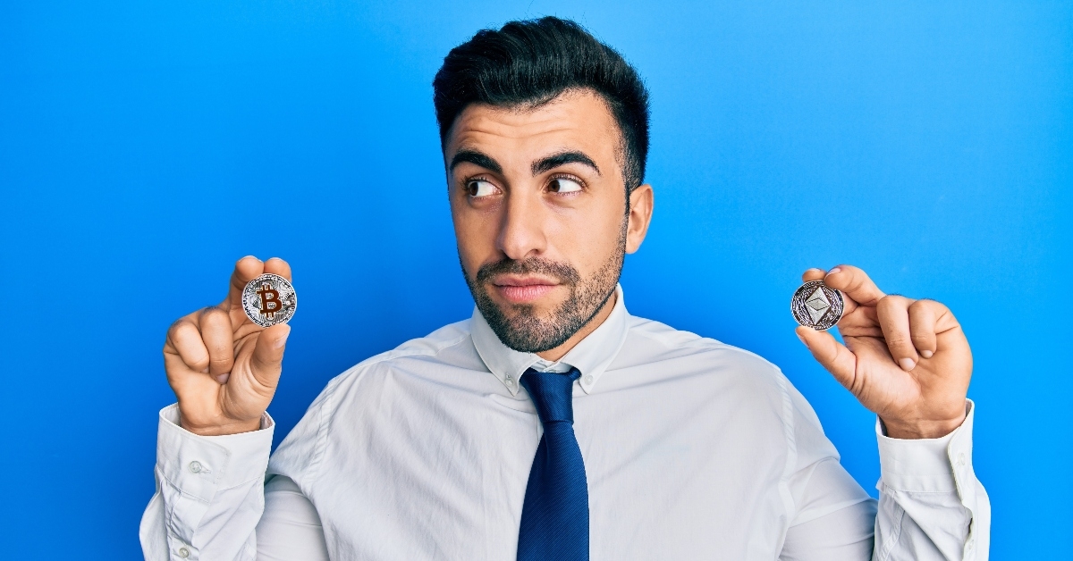 Man holding cryptocurrency coins
