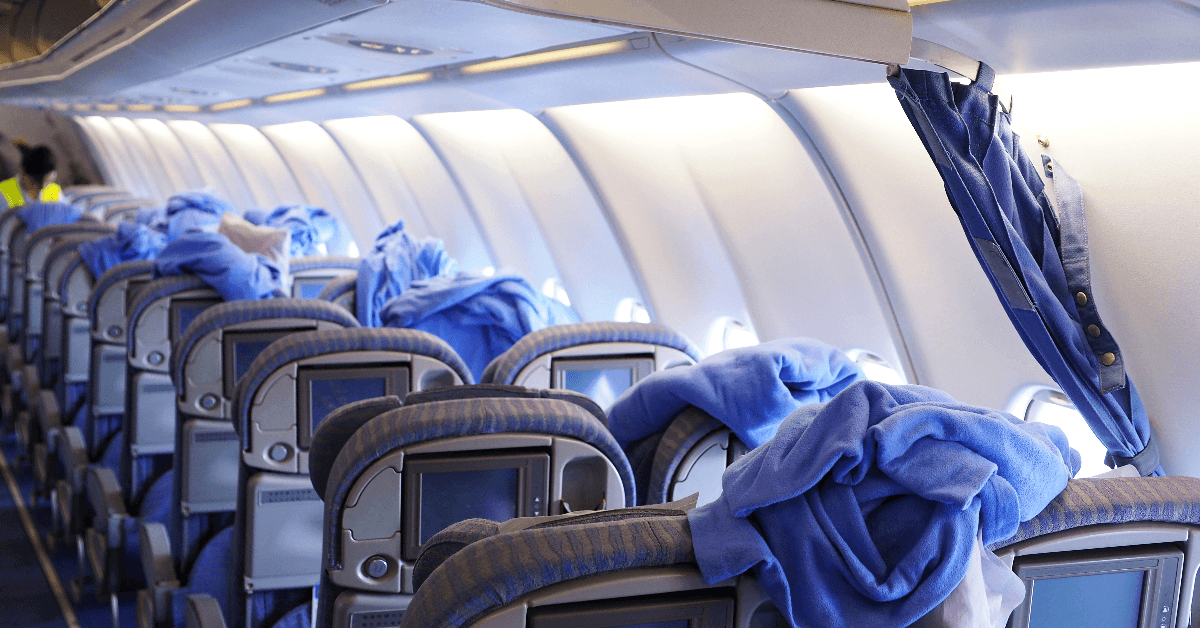 Cleaning staffs clean the airplane cabin including blankets, pillows and passenger seats