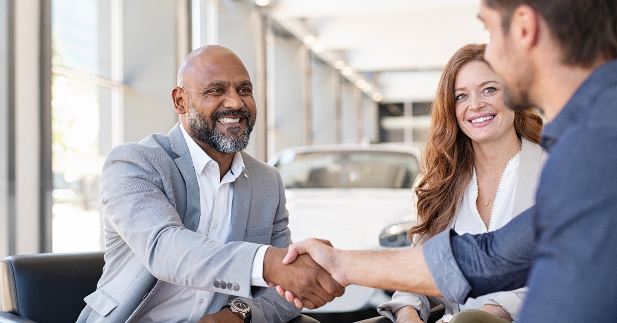 Couple at car dealership