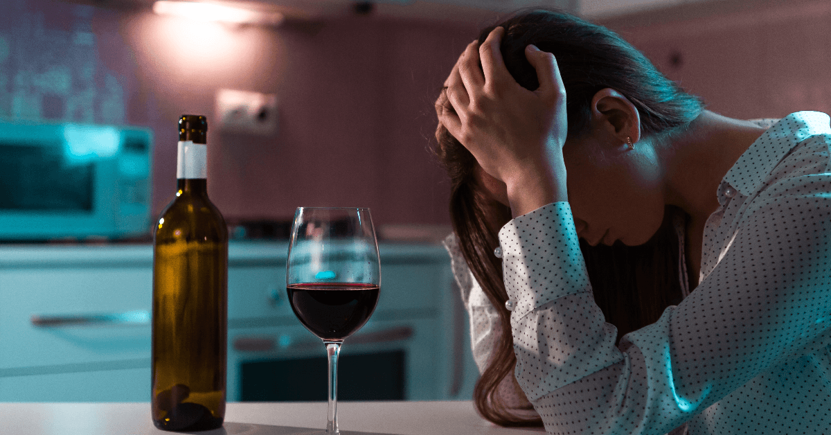 Sad woman with glass of wine