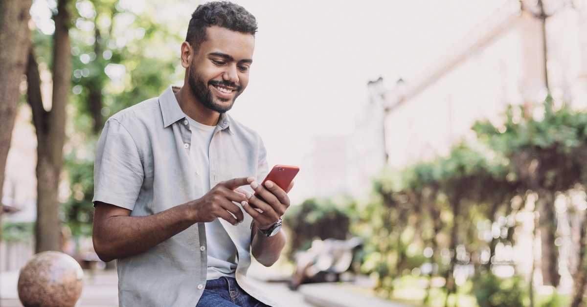 Man smiling and looking at phone