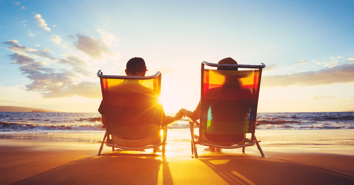 Retired couple sitting on the beach