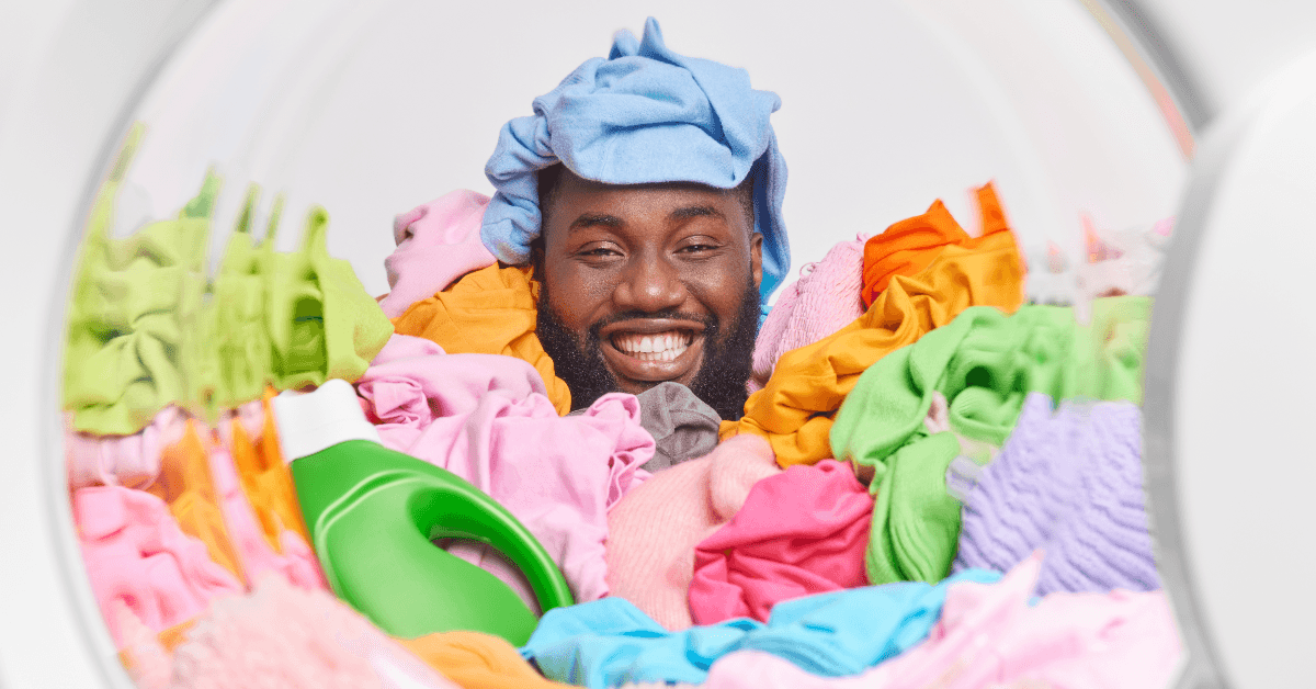 Happy man in pile of laundry