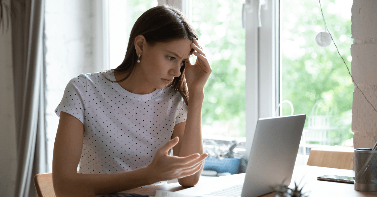 Annoyed woman looks at computer