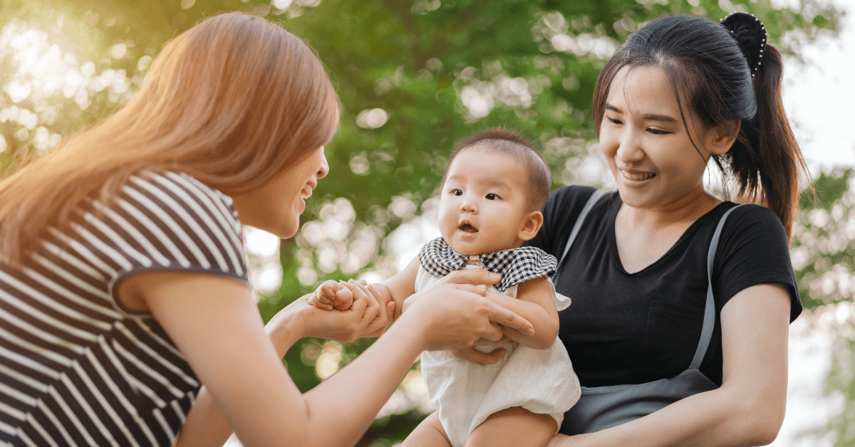 women playing with baby 