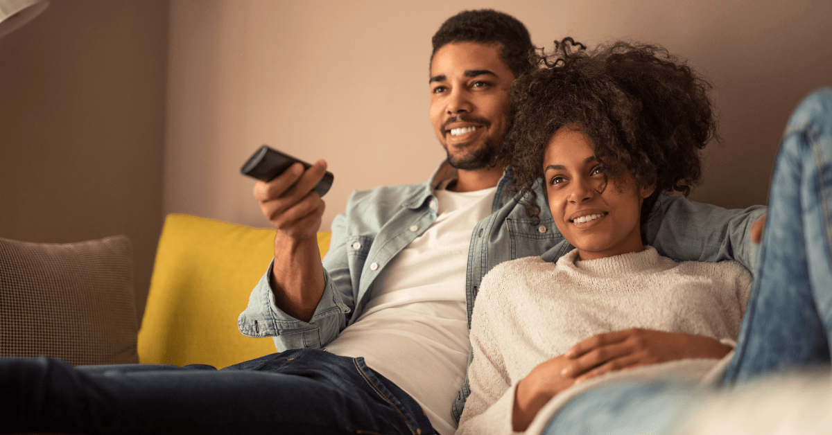 Couple watching tv at home