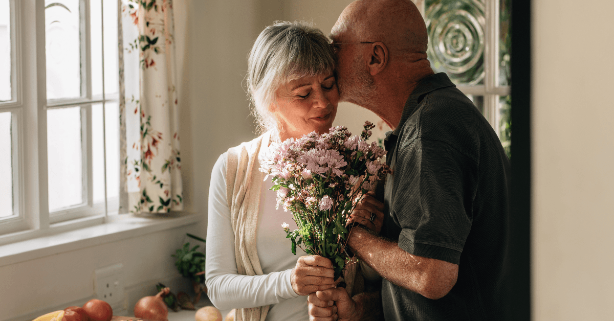 Happy senior couple with flowers