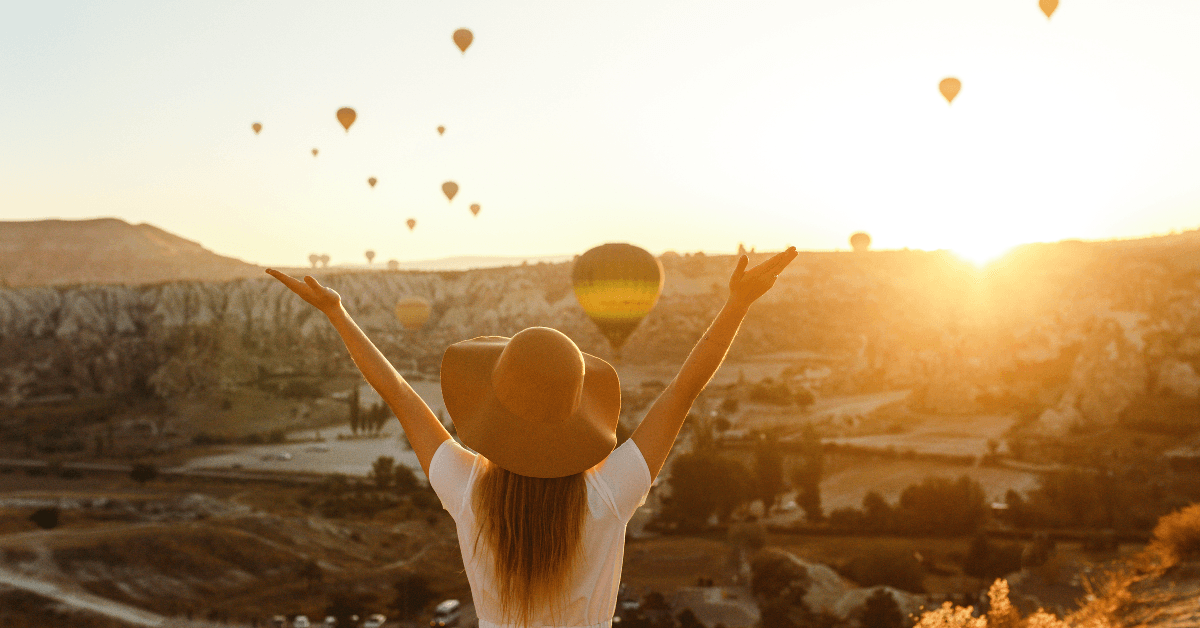 Woman looking at hot air balloons