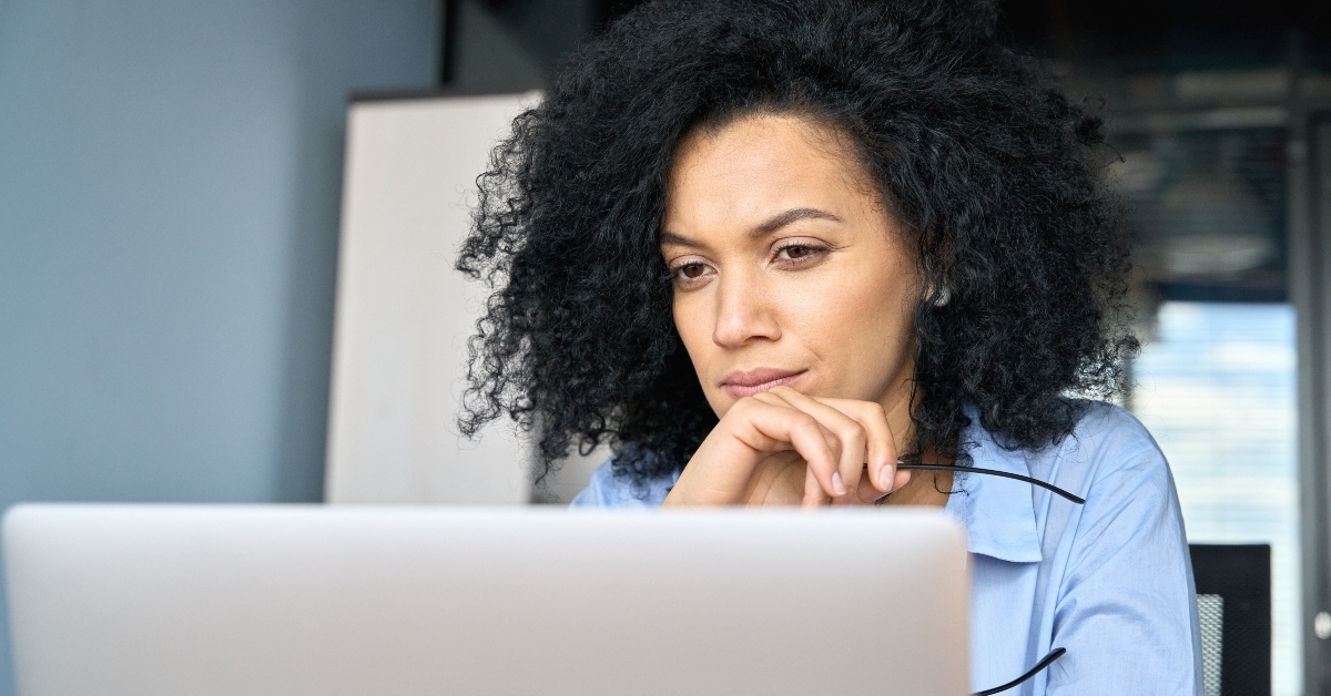 African American woman thinking at computer
