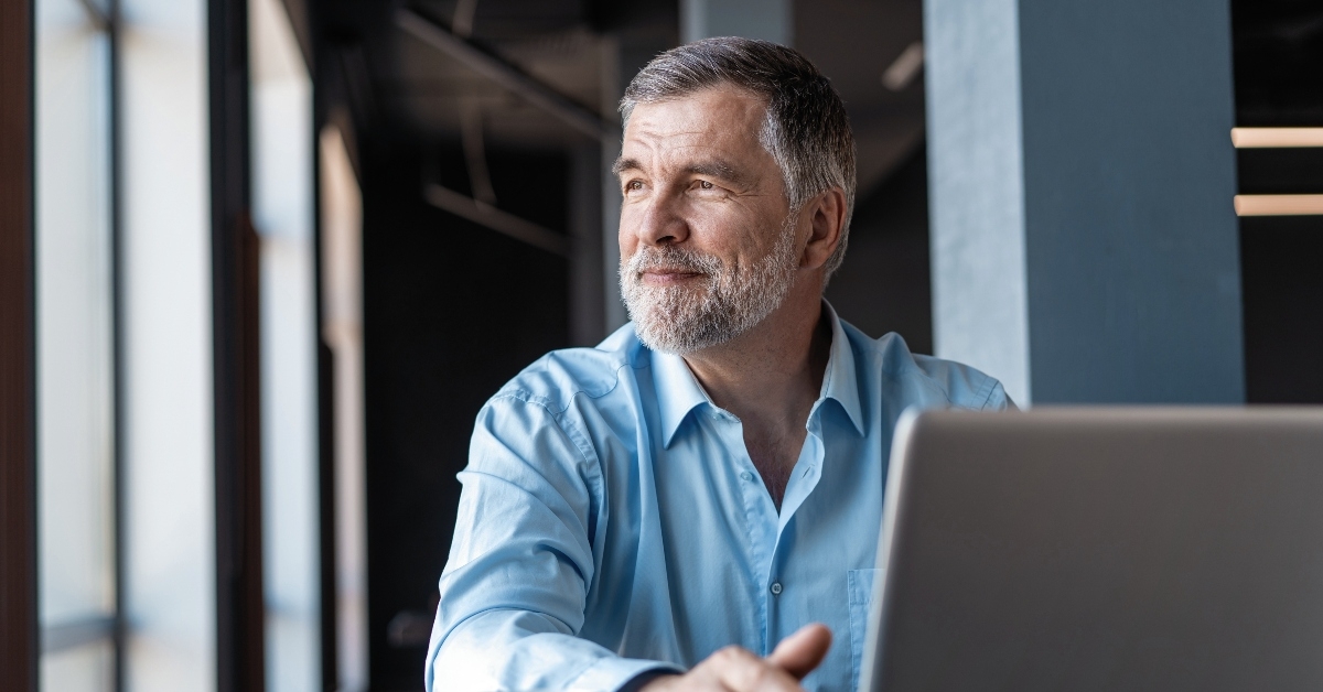 Mature businessman working on laptop