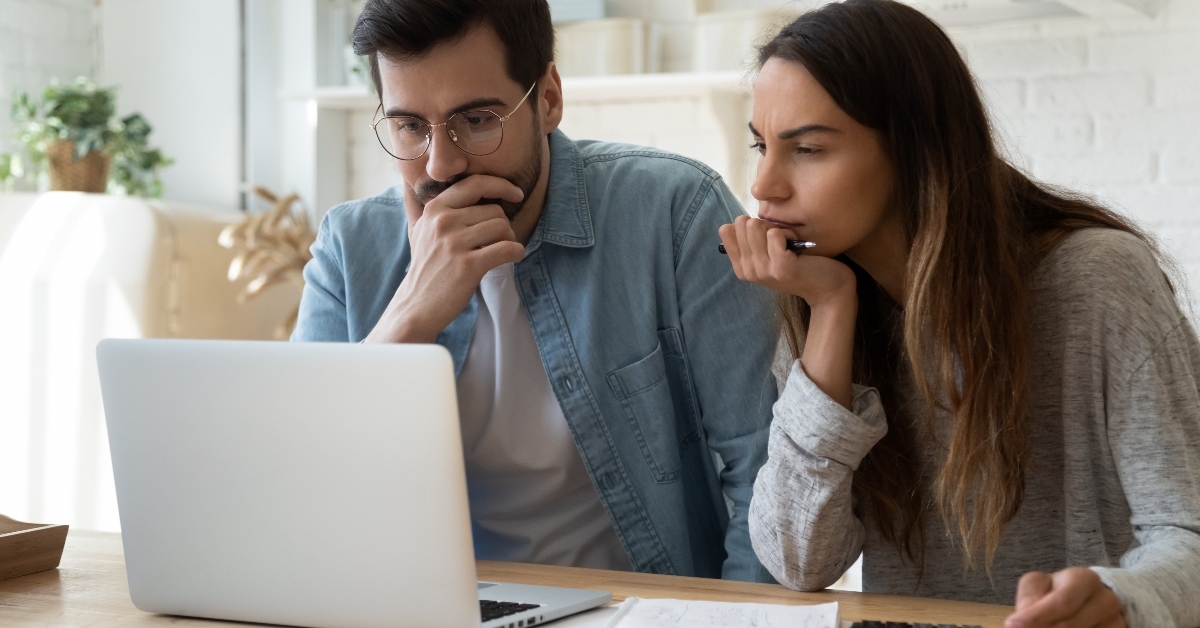 Serious couple looking at computer