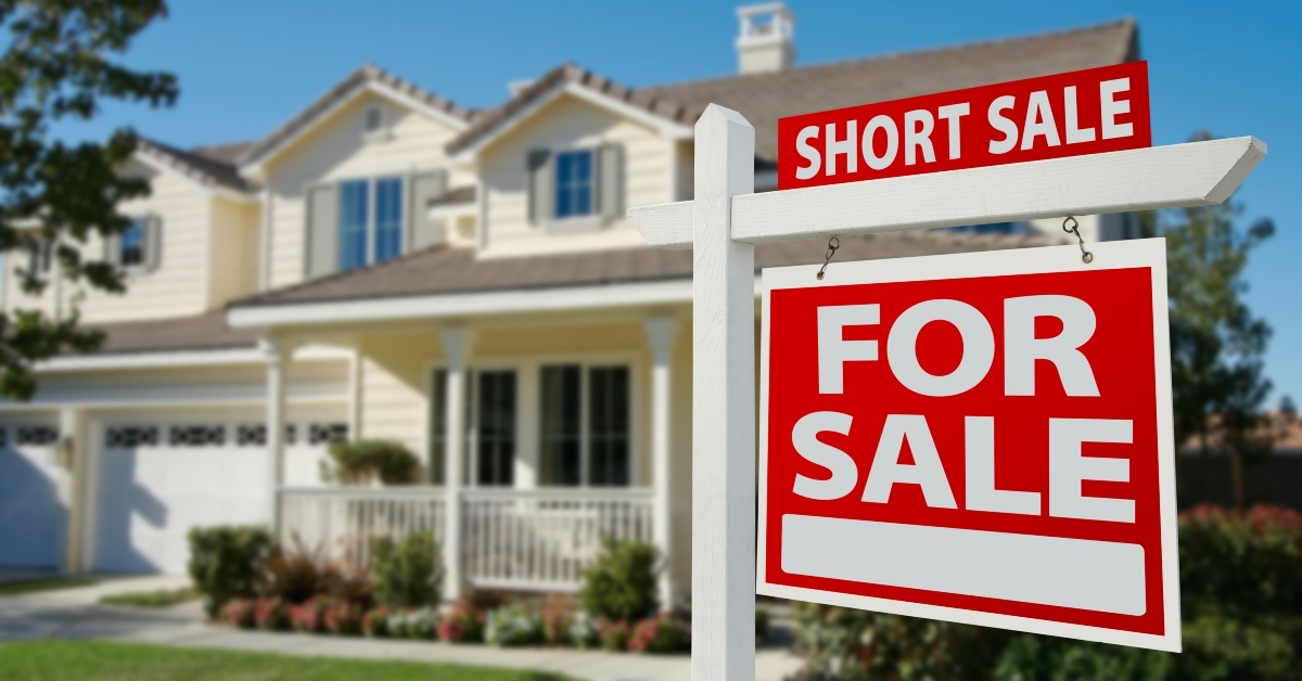 Short sale real estate sign and house