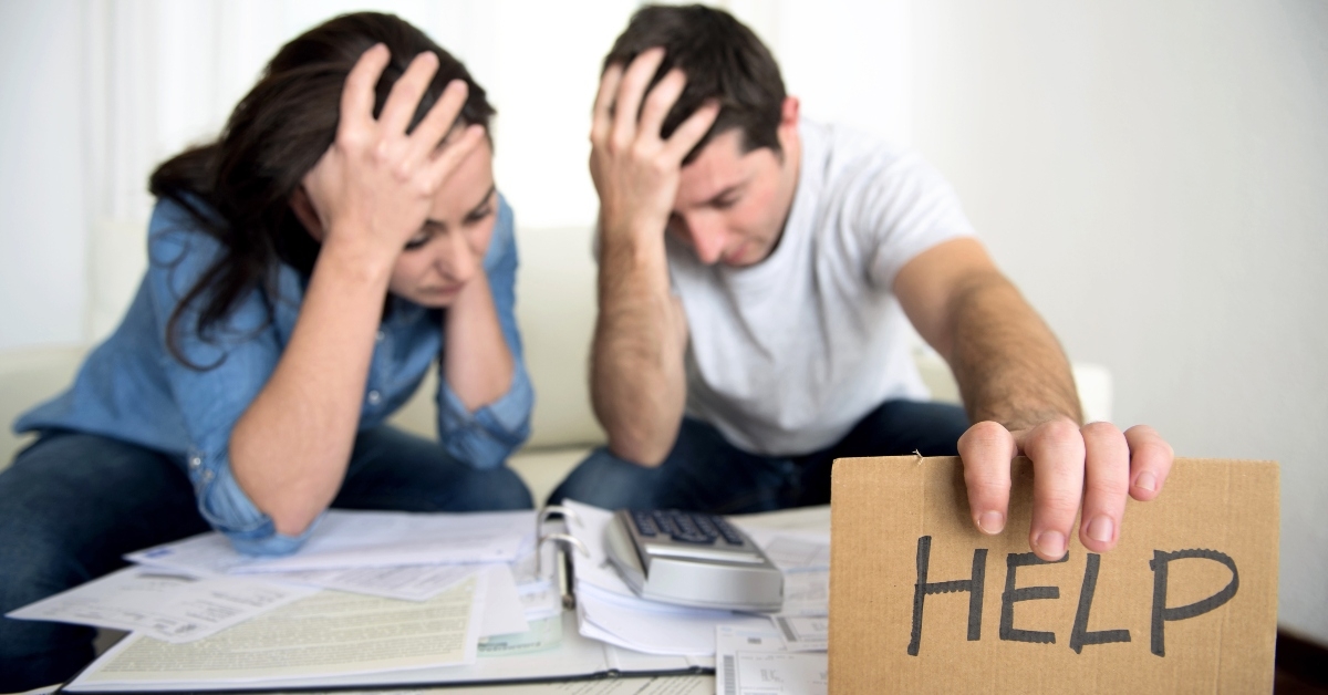 Stressed couple with help sign