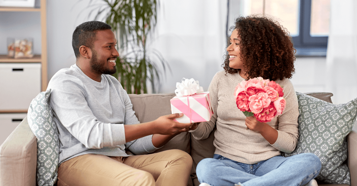 Happy couple giving gifts on Valentine's Day