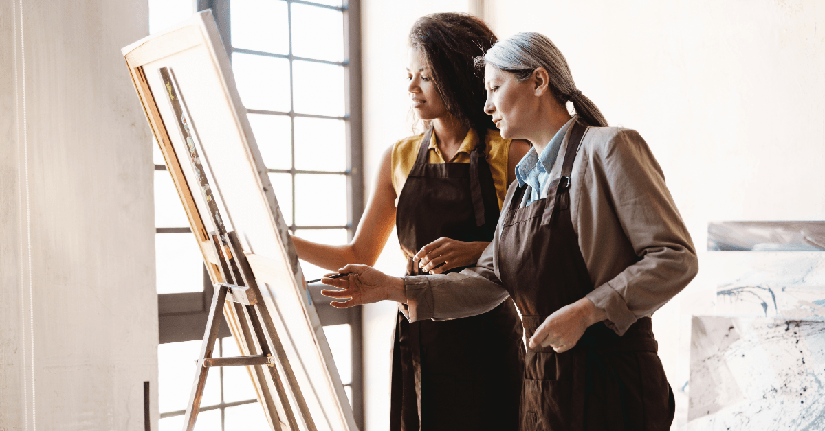 Art teacher instructing student