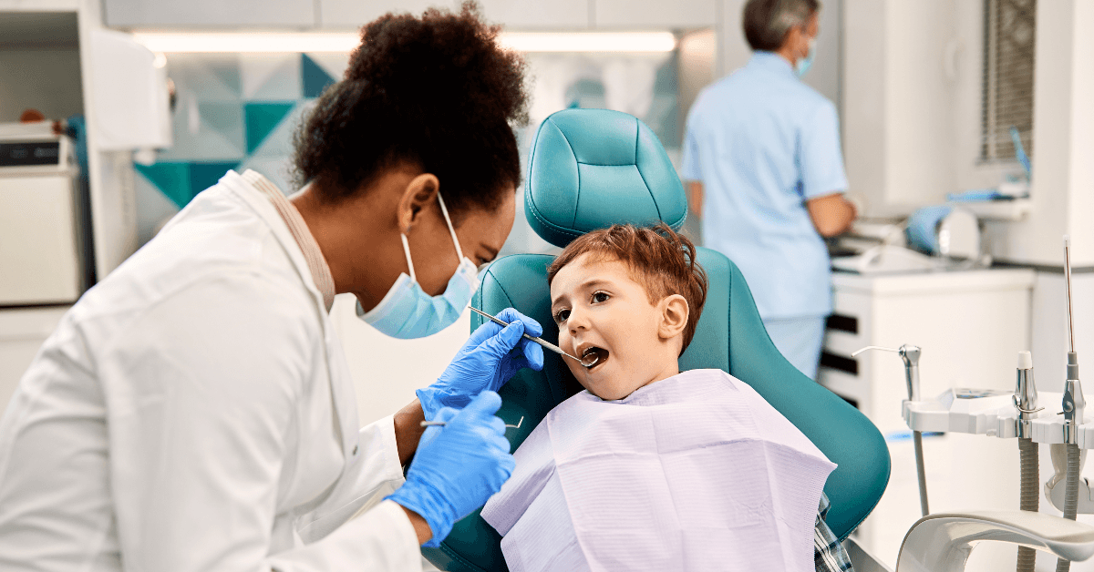 Orthodontist checking child's teeth
