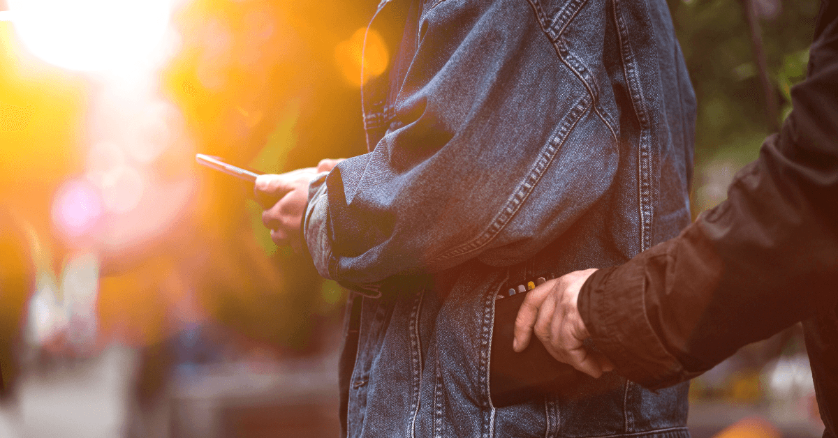 Person stealing wallet out of another person's pocket