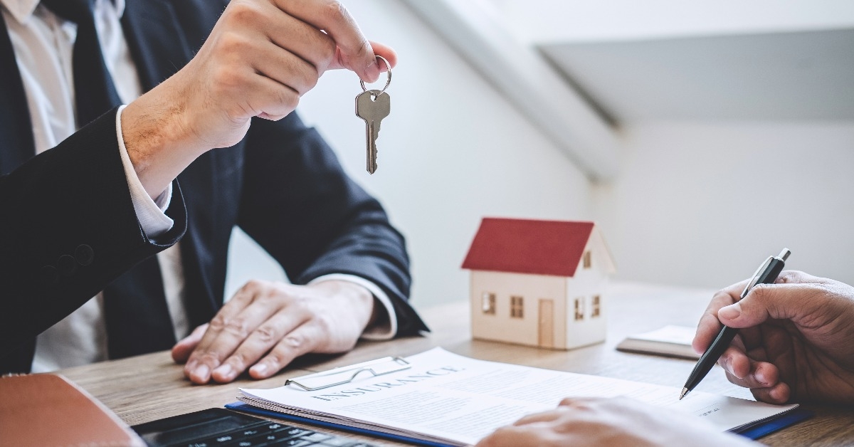 real estate agent giving house keys to client