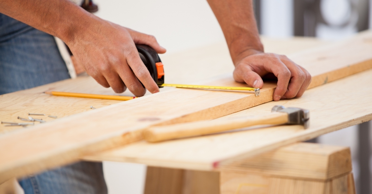 Worker measuring wood