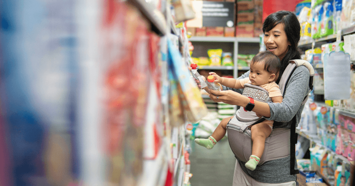 Mom grocery shopping with baby 
