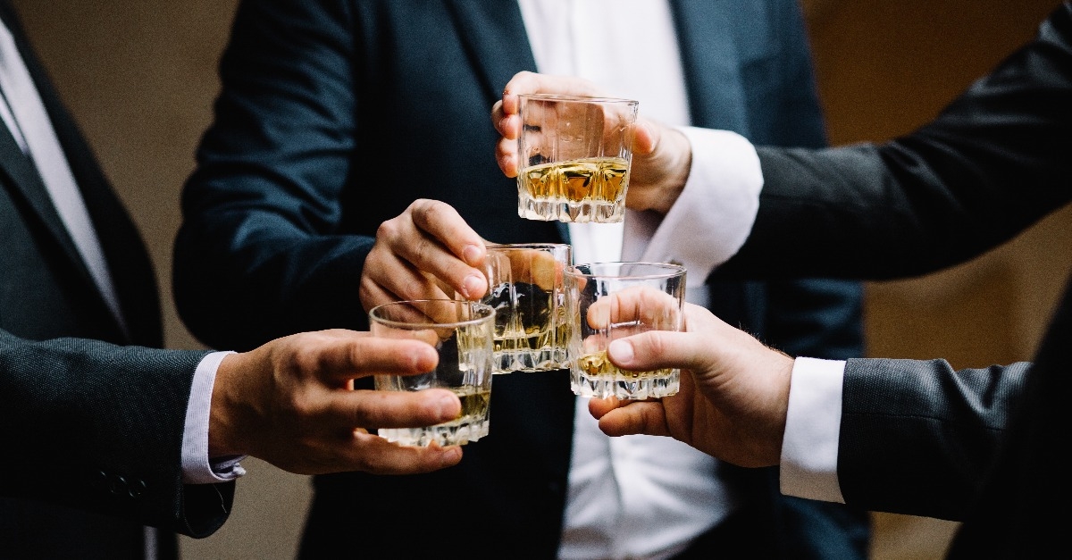 multiethnic group of businessmen spending time together drinking