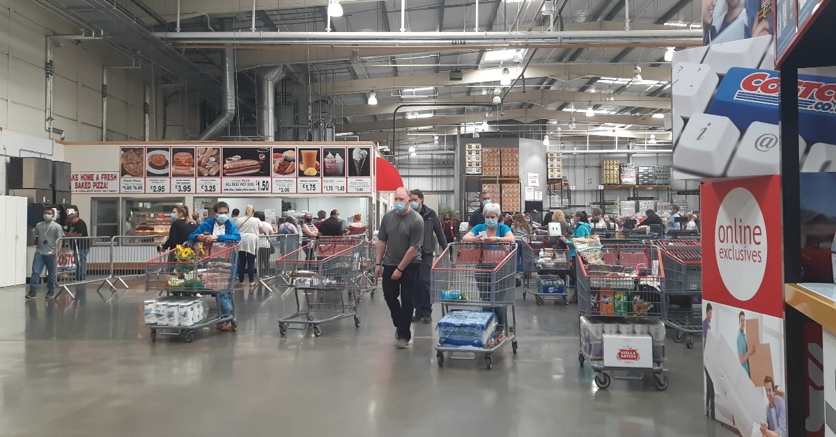 customers with shopping trolleies leaving checkout area of Costco warehouse