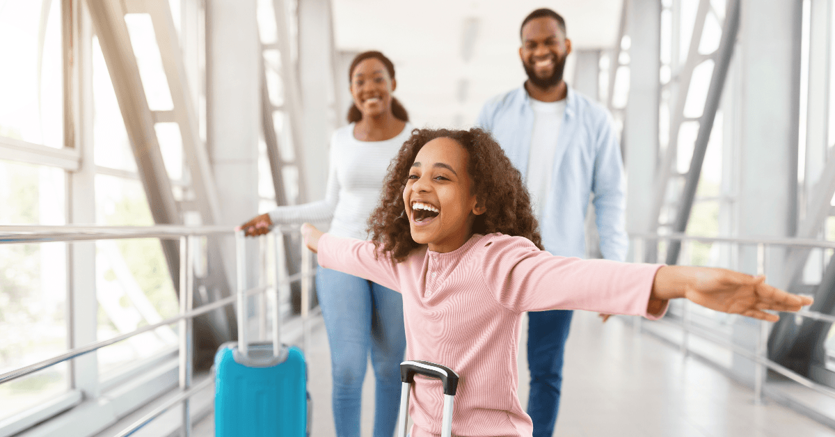 Happy family walking in airport