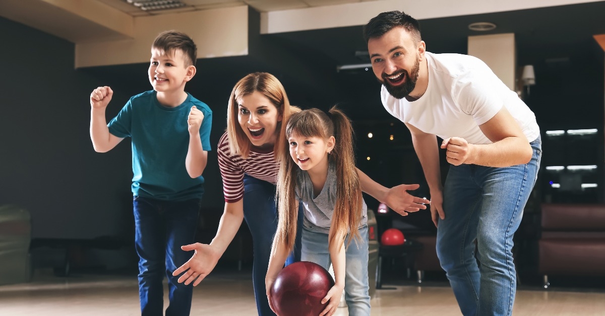 Family playing bowling in club