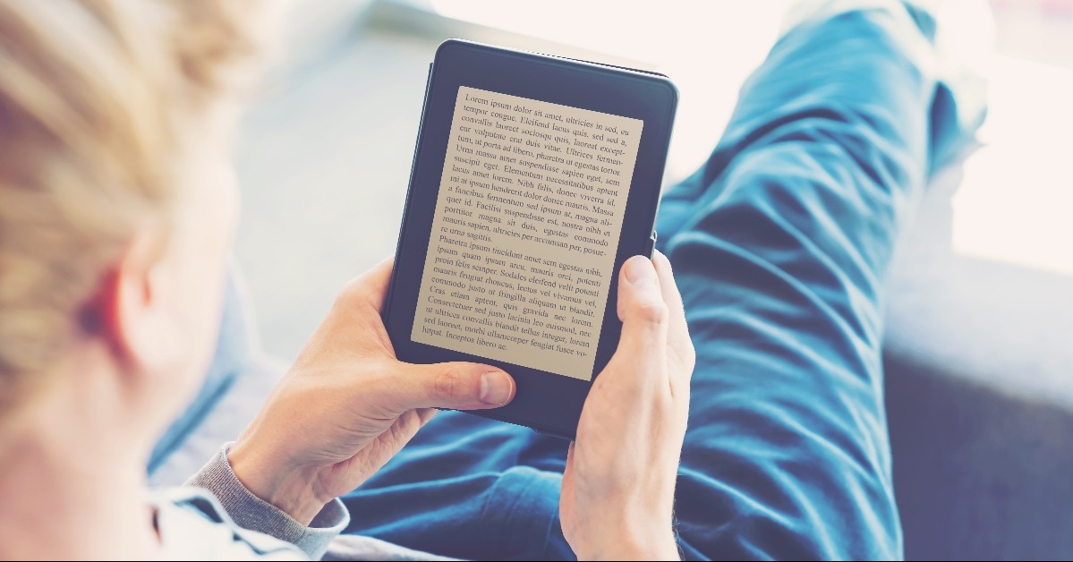 man reading a book on digital device