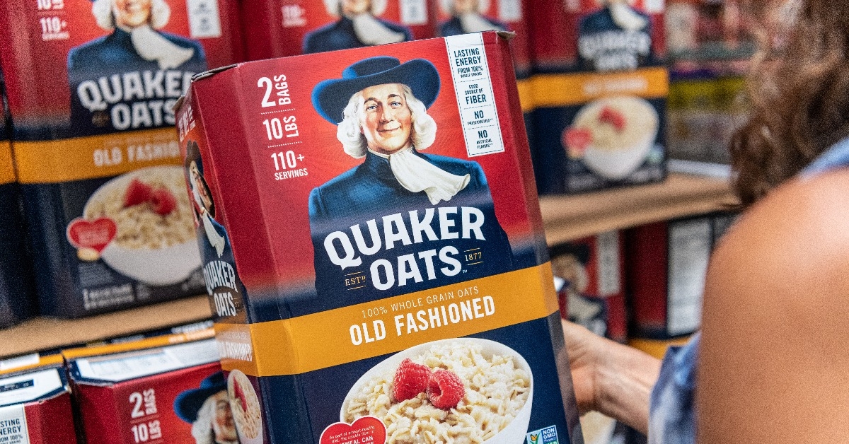 Shoppers hand holding a box of Quaker Oats