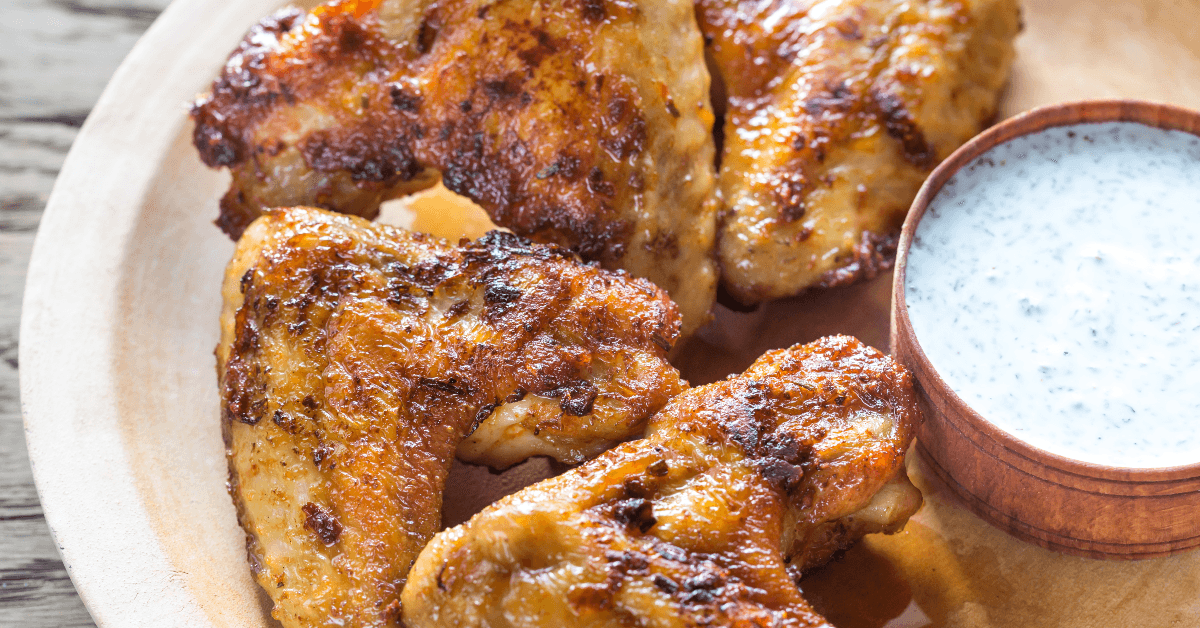 Plate of chicken and white barbecue sauce